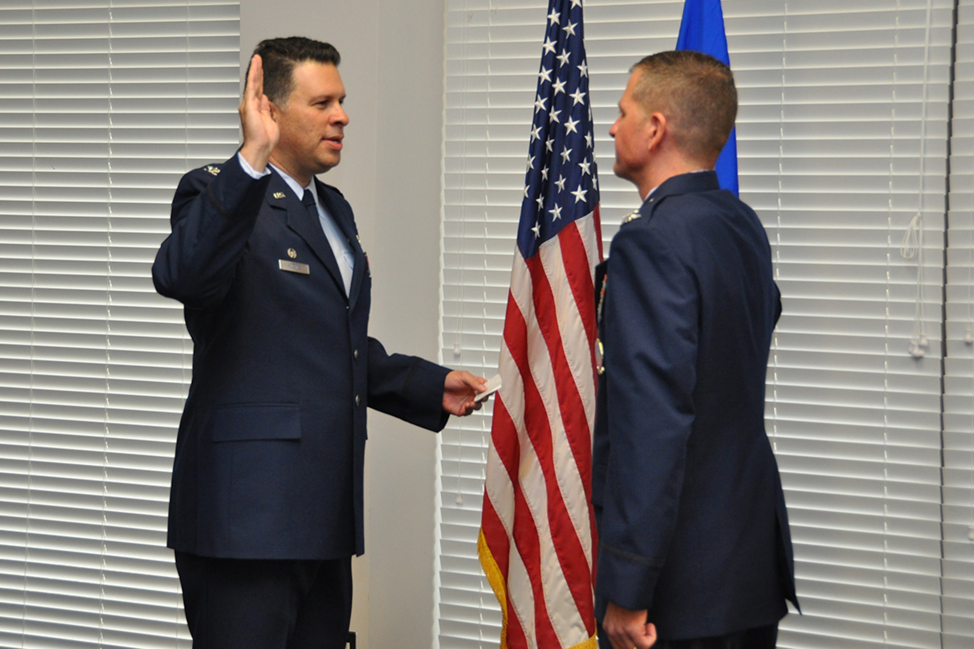 Col. Marty Hughes, 94th Mission Support Group commander, administers the oath of office to Col. Timothy H. Martz, Air Force Reserve Command Recruiting Service vice commander, and former 94th Security Forces Squadron commander, during his promotion ceremony Jan. 4, 2017 at Verhulst Hall, Dobbins Air Reserve Base, Georgia. (U.S. Air Force photo/James Branch)