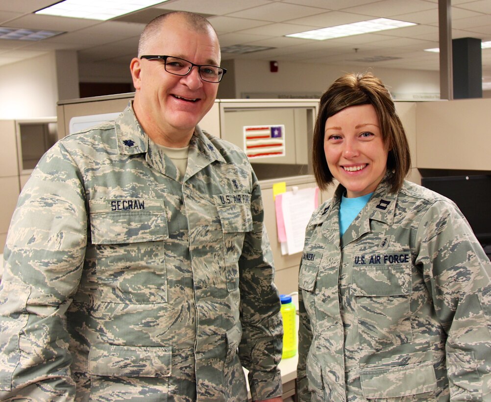 Smiling and energized for the day, Lt. Col. Steven Secraw, and Capt. Laura Raineri, 932nd Aeromedical Staging Squadron, discuss training plans and the best way forward on managing resources for the January 7, 2016 Unit Training Assembly at Scott Air Force Base, Ill.  The ASTS is a squadron under the 932nd Medical Group near Belleville, Ill.  (U.S. Air Force photo by Lt. Col. Stan Paregien)