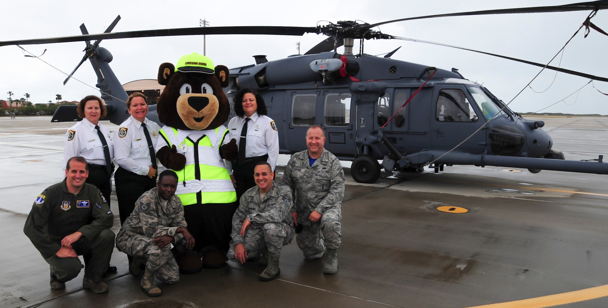 Staff Sgt. Roberto E. Maisonave (first row, third in), a client systems technician with the 920th Mission Support Group Communications Flight, poses with the Seminole County Sheriff's school crossing guards (back row) and 920th RQW safety team (front row). Maisonave designed Carl the Safety Bear which is a large part of a safety initiative in the county. (U.S. Air Force photo by Senior Airman Brandon Kalloo Sanes) 