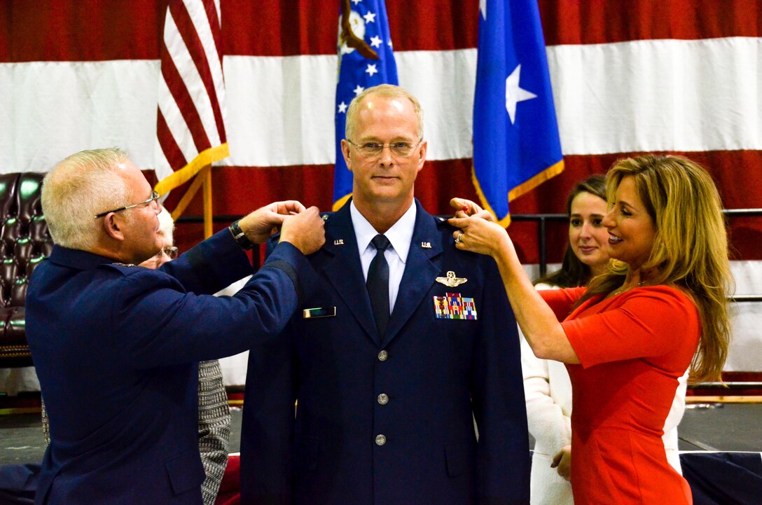 Maj. Gen. John Stokes, 22nd Air Force commander, and Karen Parker pin the star onto Brig. Gen. Steven Parker's uniform during his promotion ceremony on base Jan. 6, 2017. Parker will be the first one-star general to serve as the 94th Airlift Wing commander since 2006. (U.S. Air Force photo / Tech. Sgt. Kelly Goonan)