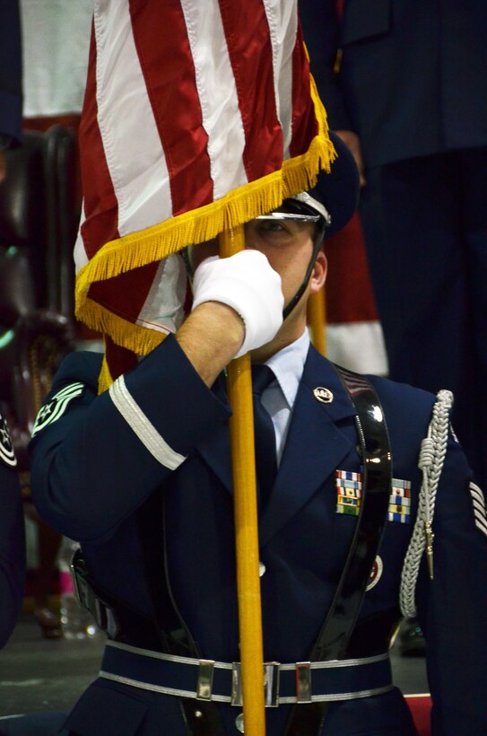 A 94th Airlift Wing Honor Guard Airman holds the American Flag during the beginning of the pinning on ceremony. The commander of the 94th AW and Dobbins Air Reserve Base was promoted to the rank of brigadier general at a ceremony on base Jan. 6, 2017.  (U.S. Air Force photo / Tech. Sgt. Kelly Goonan) 
