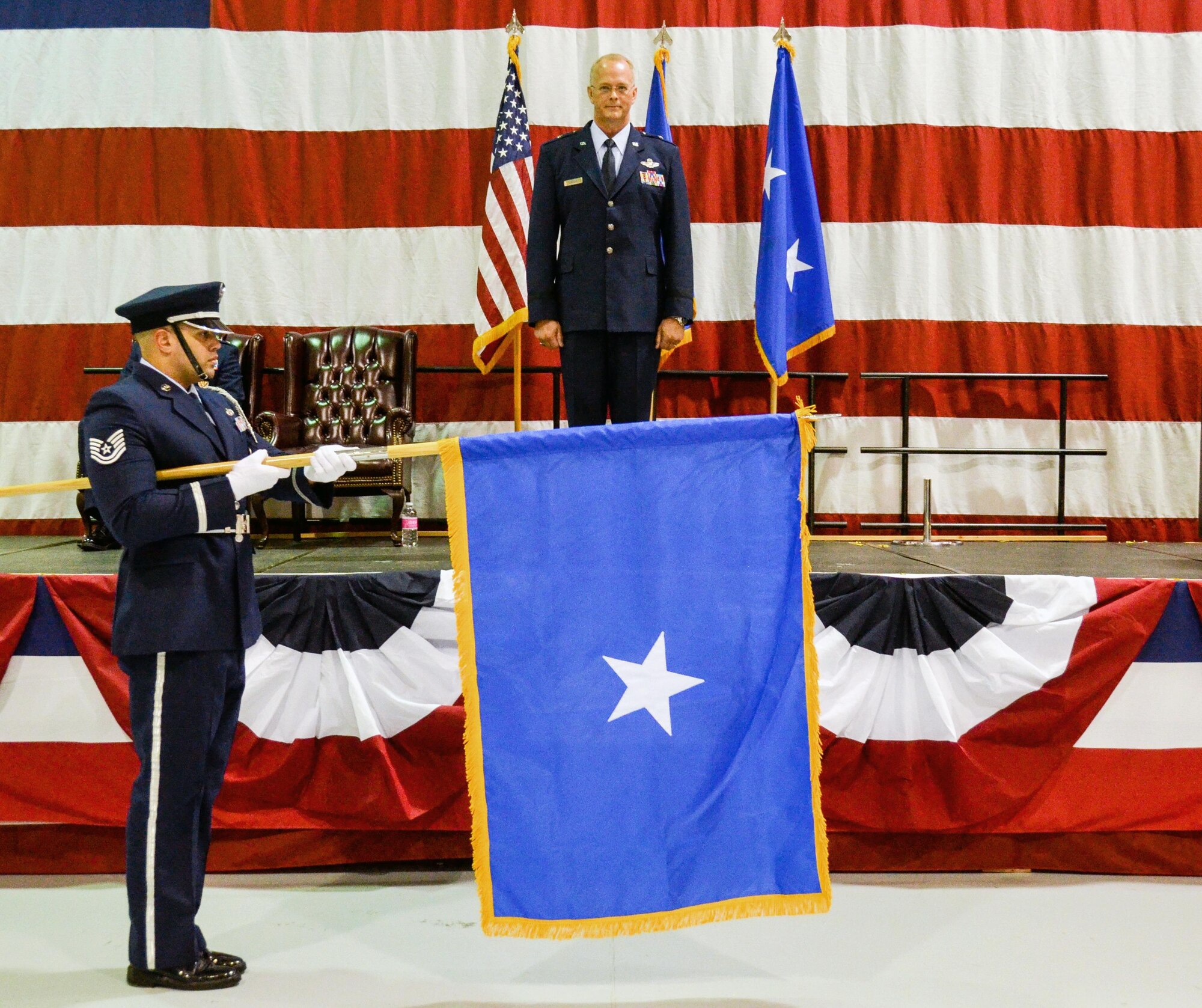 A Dobbins Honor Guard Airman unfurls the one-star general officer flag for Brig. Gen. Steven Parker during the pinning-on ceremony. The commander of the 94th Airlift Wing and Dobbins Air Reserve Base was promoted to the rank of Brig. Gen. at a ceremony on base Jan. 6, 2017. (U.S. Air Force photo / Tech. Sgt. Kelly Goonan)