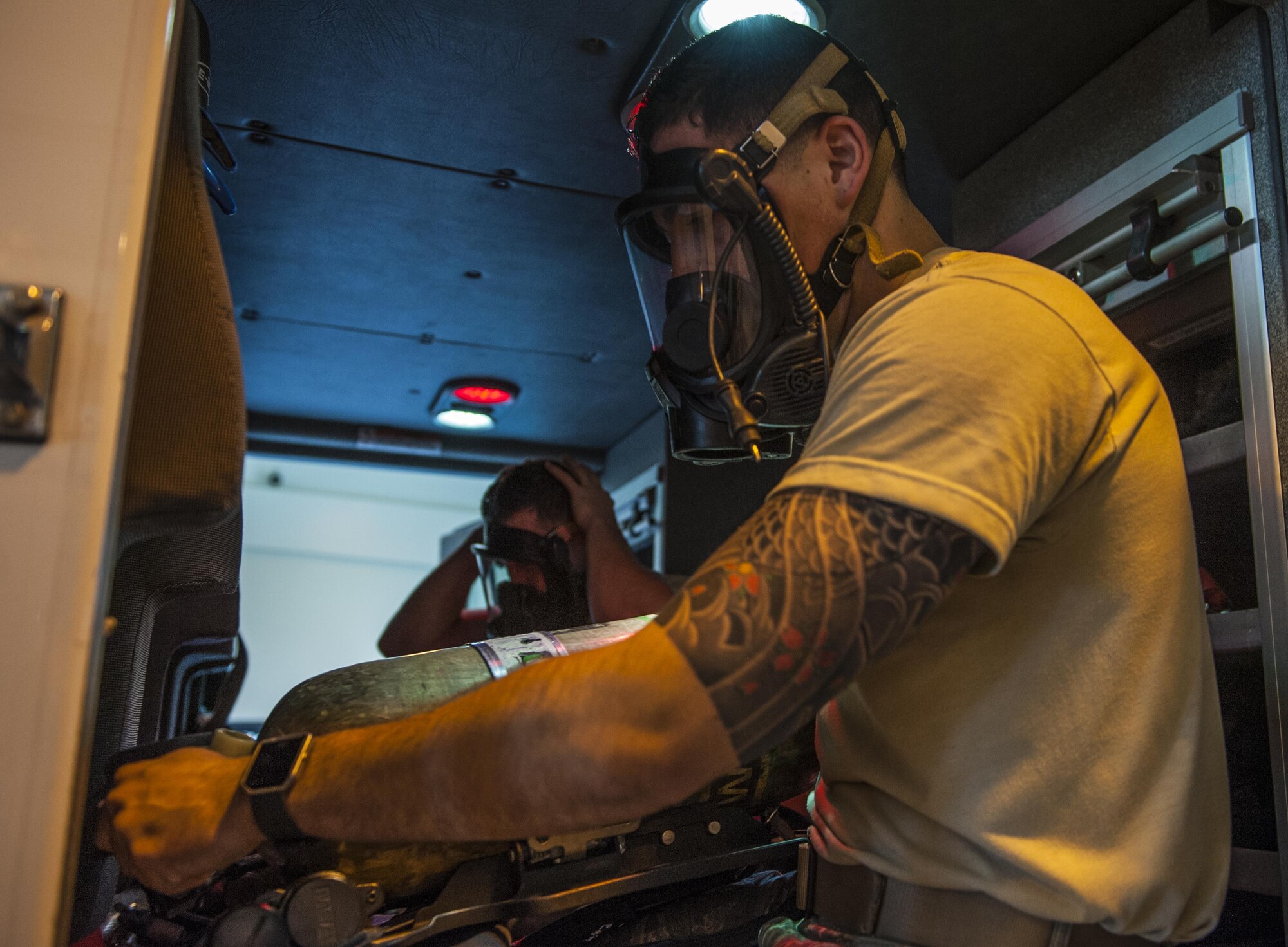 U.S. Air Force Airman 1st Class Edwin Rullan, 18th Civil Engineer Squadron firefighter, performs a mask test inside of a fire station at Kadena Air Base, Japan, Jan. 5, 2017. One of the key supporting roles of the fire department is supporting pilots during in-flight emergencies, providing a watchful eye to keep the base populace and pilots safe. (U.S. Air Force photo by Airman 1st Class Nick Emerick/Released) 