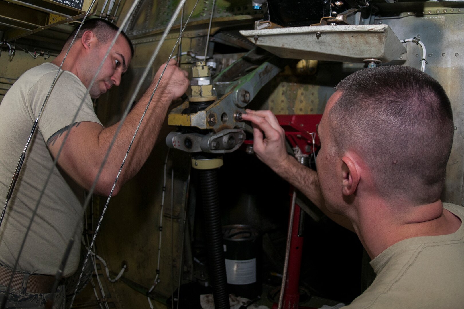 Tech Sgt. Trevor Gray and Master Sgt. Jared Richmond, 434th Maintenance Group repair and reclamation technicians, reinstall a stabilizer trim actuator on Jan. 8, 2017 at Grissom Air Reserve Base, Ind. The actuator is located in a small compartment in the tail of the aircraft often referred to as the “hellhole.” (U.S. Air Force photo/Staff Sgt. Dakota Bergl)