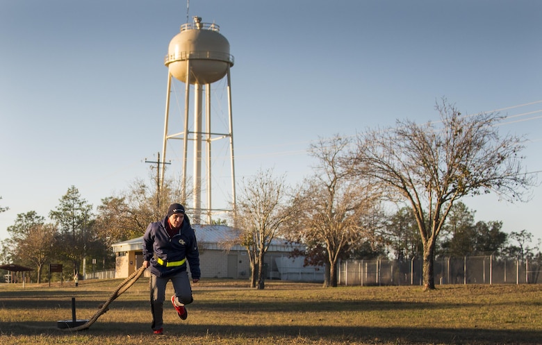 An Airman with the development and training flight pulls a weight sled during a chilly 23 degree morning physical training session Jan. 8 at Duke Field.  The Airmen within the flight attend the monthly training assembly and learn about the Air Force and Reserve prior to going to basic military training.  (U.S. Air Force photo/Tech. Sgt. Sam King)