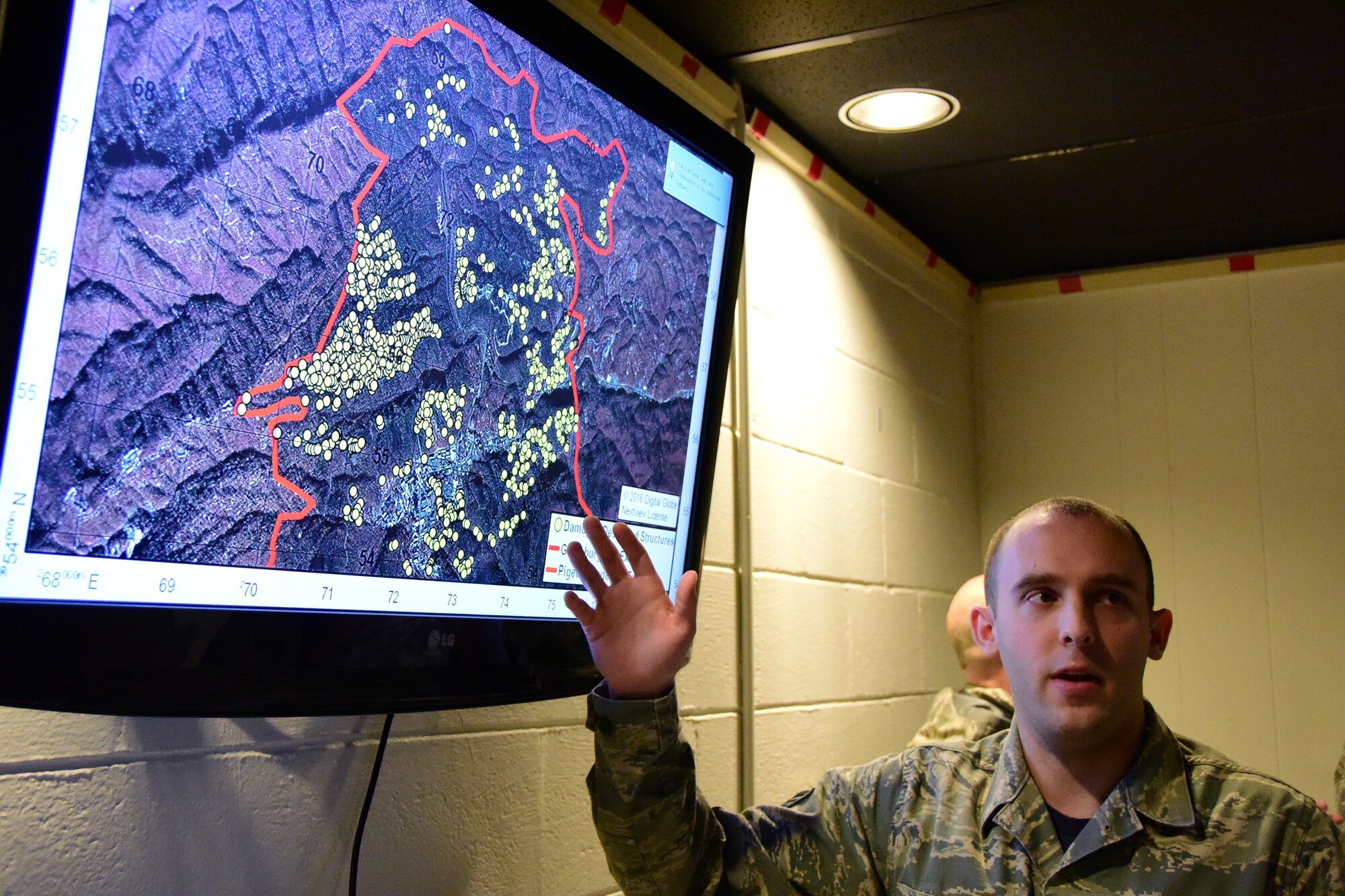 Staff Sgt. Nicholas, a member of the 236th Intelligence Support, presents a map of the fires in east Tennessee on Jan. 7, 2017 a Berry Field Air National Guard Base in Nashville, Tenn. The 236th IS provided valuable imagery and mapping support to the Tennessee Emergency Management Agency and other civilian agencies fighting the fires. 