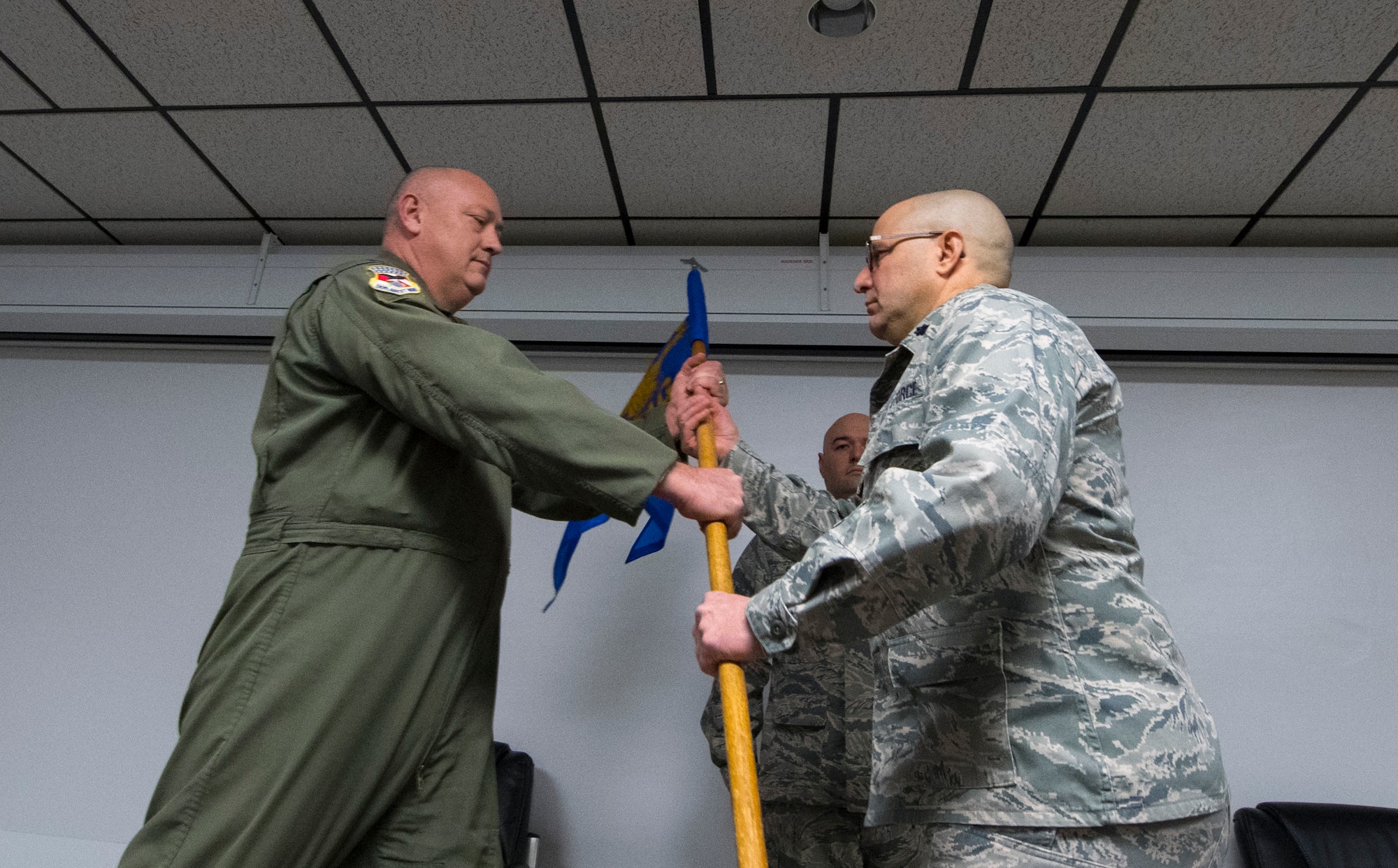 Lt. Col. J.D. Underwood accepts the 130th Medical Group guidon from 130th Airlift Wing Commander Col. Johnny Ryan during the change of command ceremony, Jan. 8, 2017, at McLaughlin Air National Guard Base, Charleston, W.Va. Lt. Col. Underwood assumed command from Col. Kurt Minne. (U.S. Air National Guard Photo by Tech. Sgt. De-Juan Haley)
