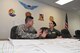 Maj. Kathleen Fabrizi (right), continuous process improvement director for the Pennsylvania National Guard, provides mentorship to Capt. Mark Martella, assistant operations officer for the 28th Combat Aviation Brigade, as he conducts work on his LSS project at the brigade's armory, May 24, 2016. The Pennsylvania National Guard has held six Lean Six Sigma classes in an effort to train soldiers and airmen throughout the organization to institutionalize a culture of reducing waste and continuous process improvement. (U.S. Air National Guard photo by Tech. Sgt. Ted Nichols/Released)