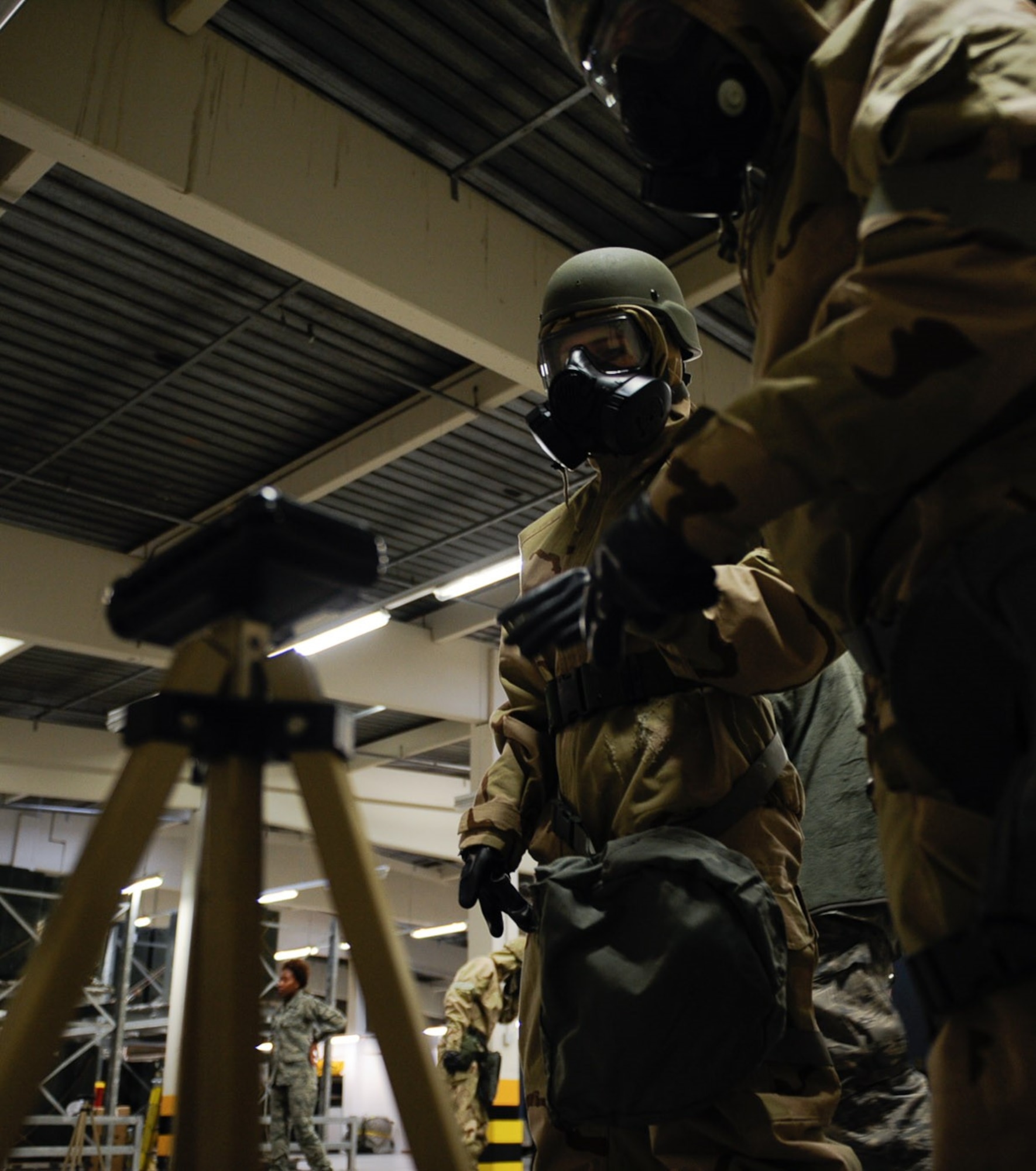 1st Lt. Michelle McMillen, 37th Airlift Squadron C-130J pilot (left), assists another Airman in examining M8 paper during a chemical, biological, radiological, or nuclear defense course at Ramstein Air Base, Germany, Jan. 4, 2017. Airmen taking the CBRN defense course learn how to use M8 detector paper to identify chemical agents such as G and V nerve agents and H and L blister agents. (U.S. Air Force photo by Airman 1st Class Savannah L. Waters)

