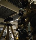 1st Lt. Michelle McMillen, 37th Airlift Squadron C-130J pilot (left), assists another Airman in examining M8 paper during a chemical, biological, radiological, or nuclear defense course at Ramstein Air Base, Germany, Jan. 4, 2017. Airmen taking the CBRN defense course learn how to use M8 detector paper to identify chemical agents such as G and V nerve agents and H and L blister agents. (U.S. Air Force photo by Airman 1st Class Savannah L. Waters)

