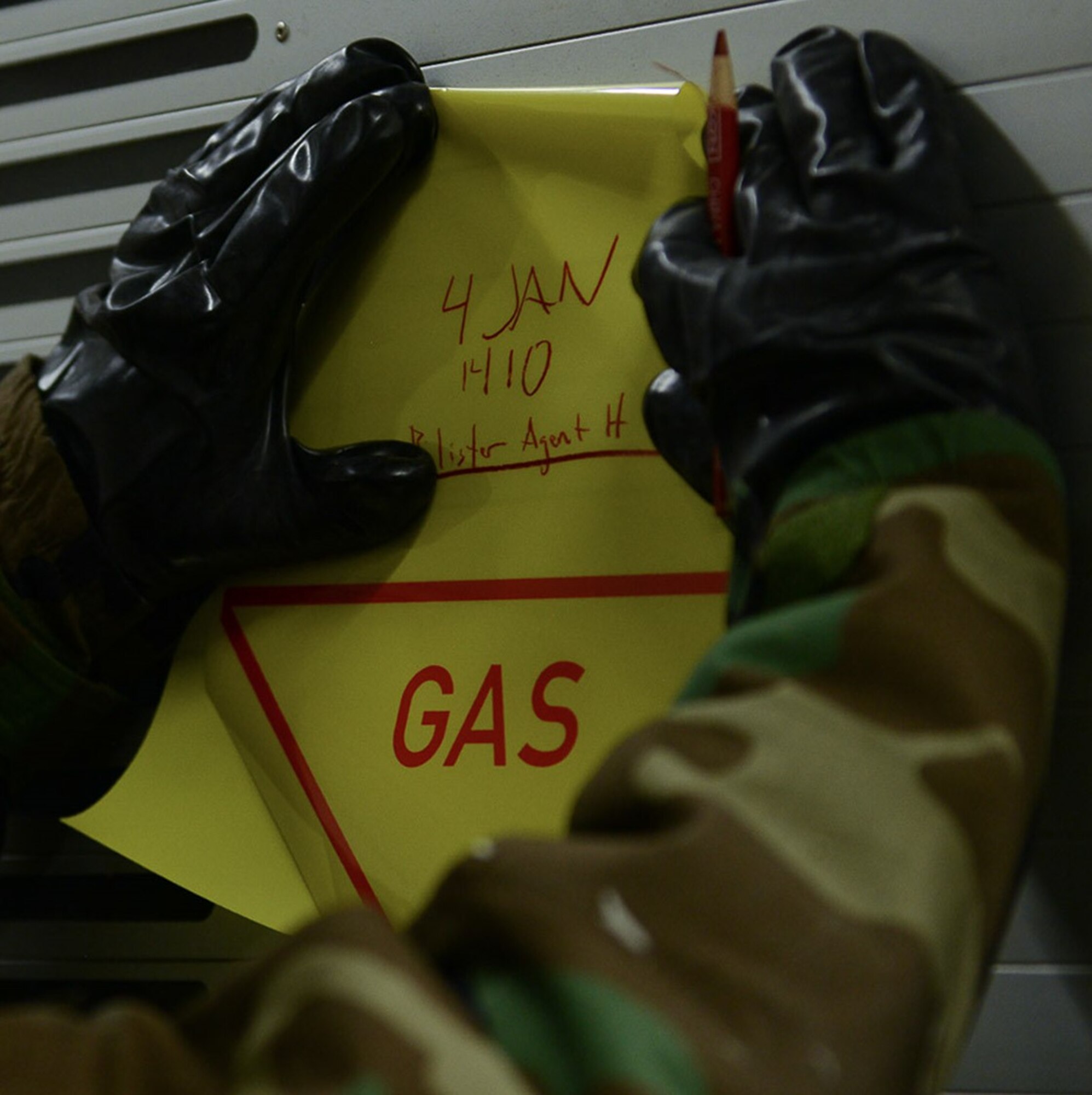 A chemical, biological, radiological, or nuclear defense course participant posts a contamination sign on the back of a truck during a CBRN defense course at Ramstein Air Base, Germany, Jan. 4, 2017. During the CBRN defense course, Airmen are taught how to inspect equipment, use detection equipment, and prepare for CBRN attacks. (U.S. Air Force photo by Airman 1st Class Savannah L. Waters)