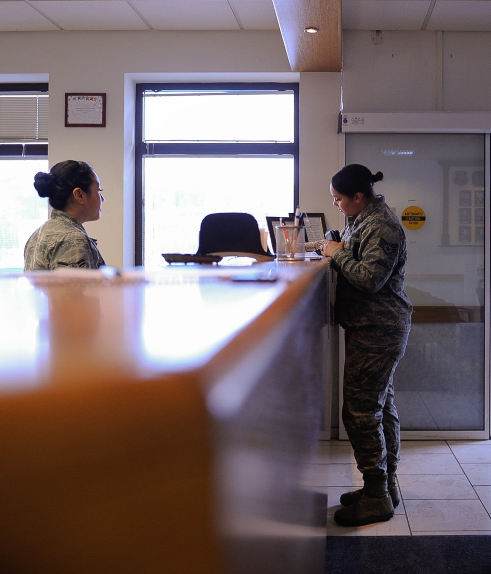 Airman 1st Class Daniela Pastor, 86th Airlift Wing Judge Advocate paralegal, assists Staff Sgt. Tynisia Hains, 86th Force Support Squadron installation patrolman, at the base legal office at Ramstein Air Base, Germany, Jan. 5, 2017. Ramstein’s Tax Center is located at the base legal office, where volunteers and Airmen work to ensure active-duty members are provided with the tax assistance they need. (U.S. Air Force photo by Airman 1st Class Savannah L. Waters)