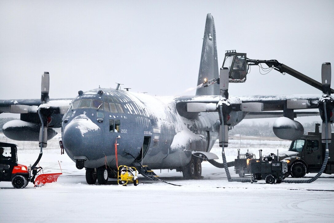 New York Air National Guardsmen use de-icing trucks to prevent snow buildup on an HC-130 Hercules aircraft during a sudden major snowstorm at Francis S. Gabreski Air National Guard Base in Westhampton Beach, N.Y., Jan. 6, 2017. The airmen are assigned to the New York Air National Guard’s 106th Rescue Wing and Civil Engineering Squadron. Airmen also plowed the runway during the storm, allowing operations to continue without delay. Air National Guard photo by Staff Sgt. Christopher S. Muncy