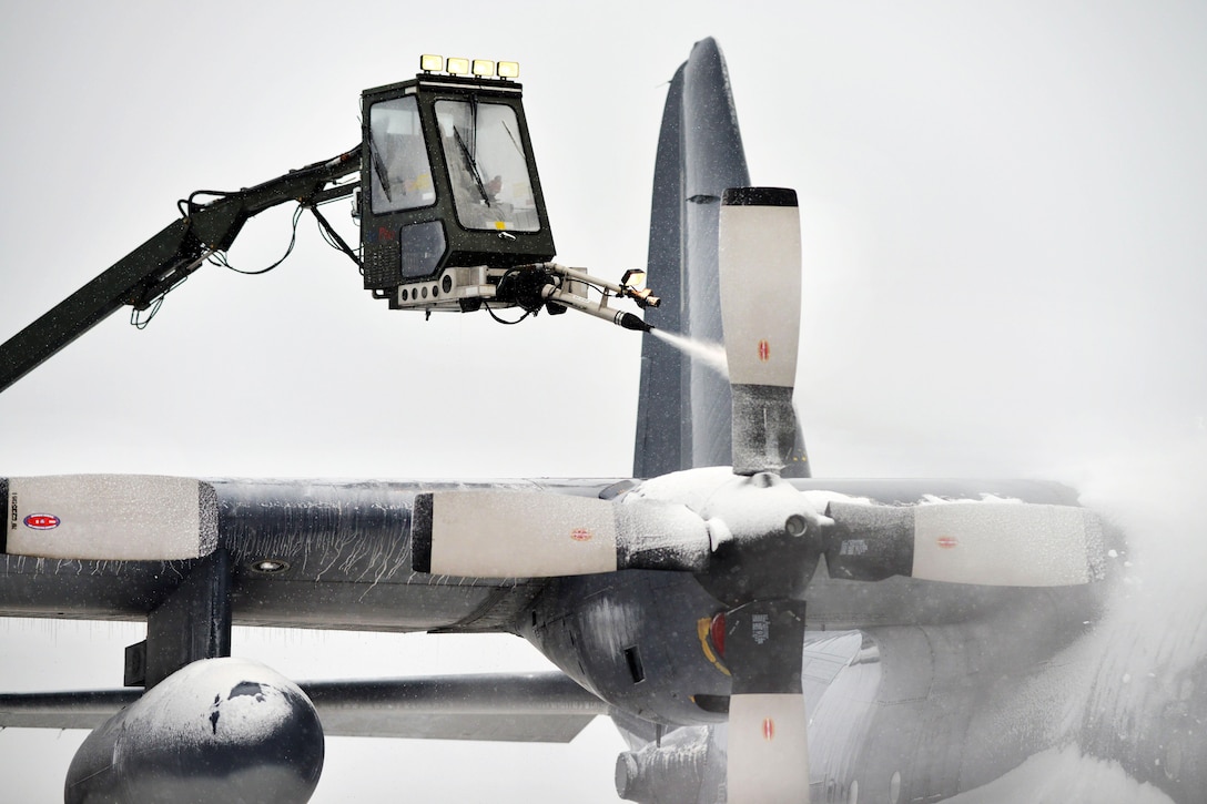 A New York Air National Guardsman de-ices the propeller blades on an HC-130 Hercules aircraft during a sudden major snowstorm at Francis S. Gabreski Air National Guard Base in Westhampton Beach, N.Y., Jan. 6, 2017. Air National Guard photo by Staff Sgt. Christopher S. Muncy