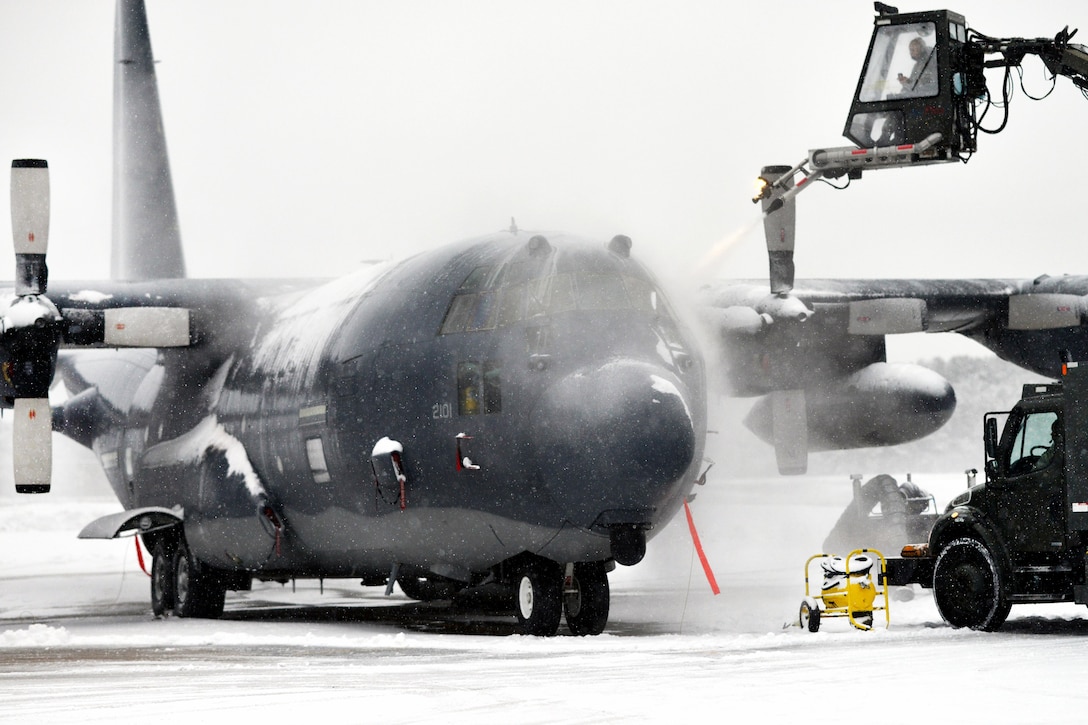 A New York Air National Guardsman de-ices the front of an HC-130 Hercules aircraft during a sudden major snowstorm at Francis S. Gabreski Air National Guard Base in Westhampton Beach, N.Y., Jan. 6, 2017. Air National Guard photo by Staff Sgt. Christopher S. Muncy