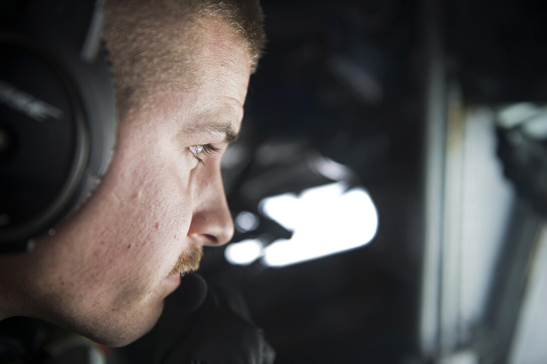 Air Force Senior Airman Jordan Kaminski controls a refueling boom from the boom operator's station aboard a KC-135 Stratotanker during aerial refueling for an Operation Freedom’s Sentinel mission over Afghanistan, Jan. 3, 2017. Kaminski is a boom operator assigned to the 340th Expeditionary Air Refueling Squadron. Air Force photo by Staff Sgt. Matthew B. Fredericks