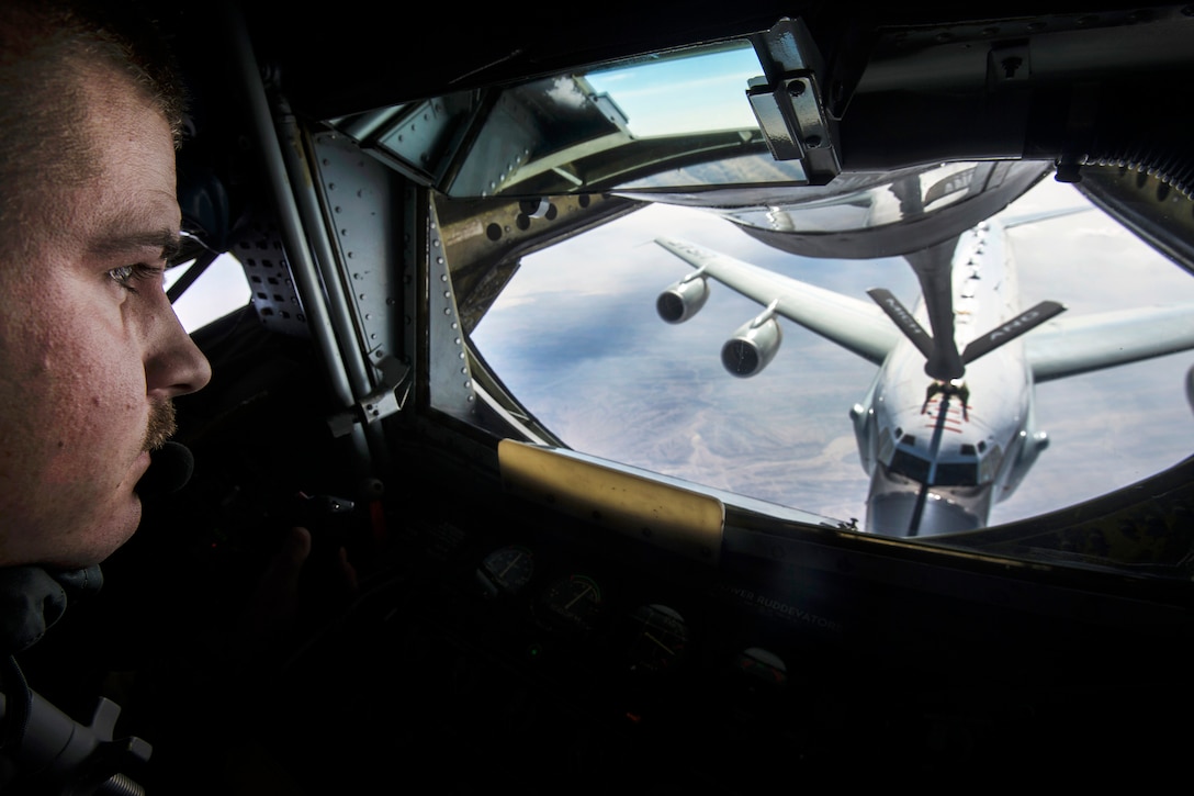 Air Force Senior Airman Jordan Kaminski controls a refueling boom from the boom operator's station as he refuels an RC-135 Rivet Joint reconnaissance aircraft during an Operation Freedom’s Sentinel mission over Afghanistan, Jan. 3, 2017. Kaminski is a boom operator assigned to the 340th Expeditionary Air Refueling Squadron. Air Force photo by Staff Sgt. Matthew B. Fredericks