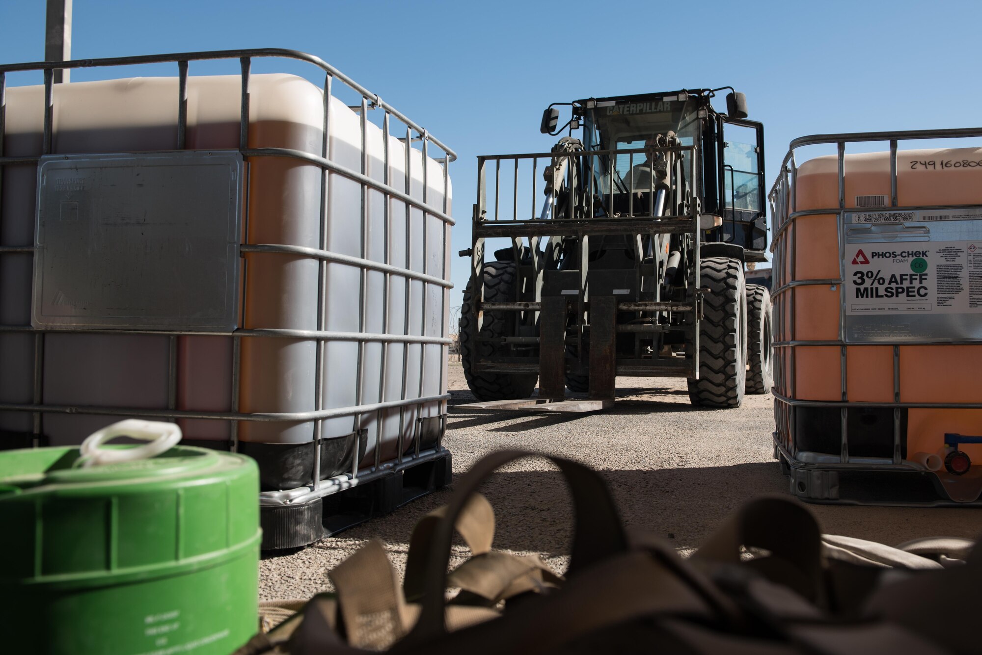 Tech. Sgt. Nathan Darke, 407th Expeditionary Civil Engineer Squadron firefighter, uses a forklift to transport a container of old fire retardant foam at the 407th Air Expeditionary Group, Jan. 6, 2016. The unit switched to a new fire retardant foam in their foam trailer, and six crash vehicles.  (U.S. Air Force photo/Master Sgt. Benjamin Wilson)(Released)