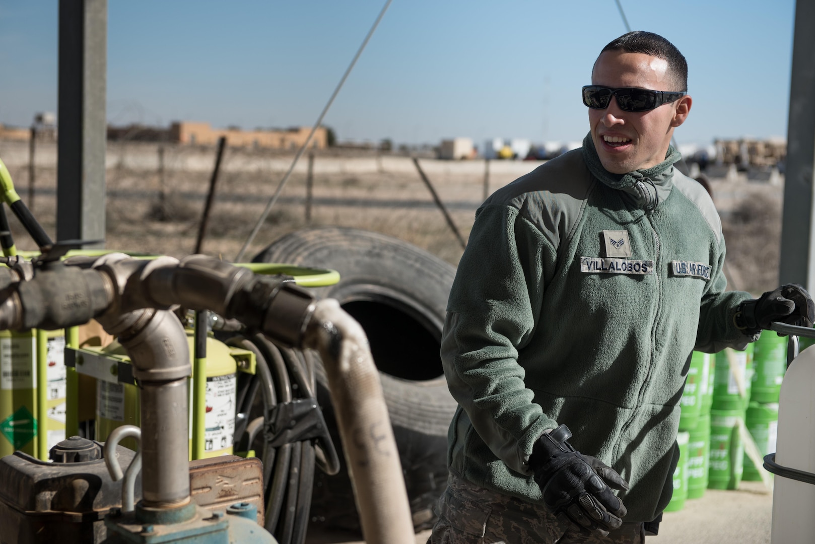 Senior Airman Francisco Villalobos, 407th Expeditionary Civil Engineer Squadron firefighter, transfers fire retardant from a foam trailer at the 407th Air Expeditionary Group, Jan. 6, 2016. The unit switched all the fire retardant foam in their inventory as part of an Air Force-wide initiative to use more environmentally friendly foam. (U.S. Air Force photo/Master Sgt. Benjamin Wilson)(Released)
