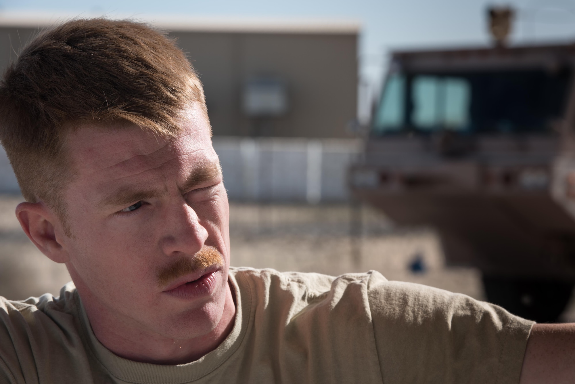 Staff Sgt. Clinton Manus, 407th Expeditionary Civil Engineer Squadron firefighter, speak with his leadership while transferring fire retardant from a foam trailer at the 407th Air Expeditionary Group, Jan. 6, 2016. The unit switched all the fire retardant foam in their inventory as part of an Air Force-wide initiative to use more environmentally friendly foam. (U.S. Air Force photo/Master Sgt. Benjamin Wilson)(Released)