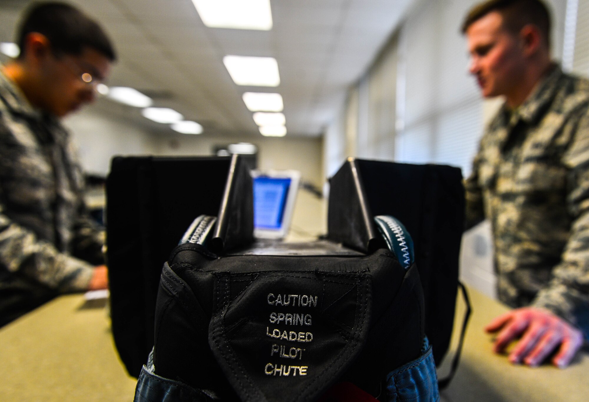 A parachute container sits on a table before inspection at Shaw Air Force Base, S.C., Jan. 4, 2017. The six-hour parachute inspection process includes unpacking, inspecting lines for infractions and replacing parts. (U.S. Air Force photo by Airman 1st Class Christopher Maldonado)