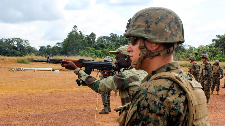 Lance Cpl. Nathaniel Madison, a rifleman with Special Purpose Marine Air-Ground Task Force Crisis Response-Africa, watches Gabonese Armed Forces soldiers fire their weapons at paper targets during a range at Camp Mokekou, Gabon, Nov. 24, 2016. Marines trained together with the Gabonese Agency for National Parks and Gabonese Armed Forces to help combat illicit trafficking in the region. 