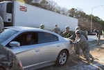 Alabama National Guard Soldiers from the 128th Military Police Company push a stuck motorist out of a median Birmingham, Alabama, Jan. 7, 2017. 