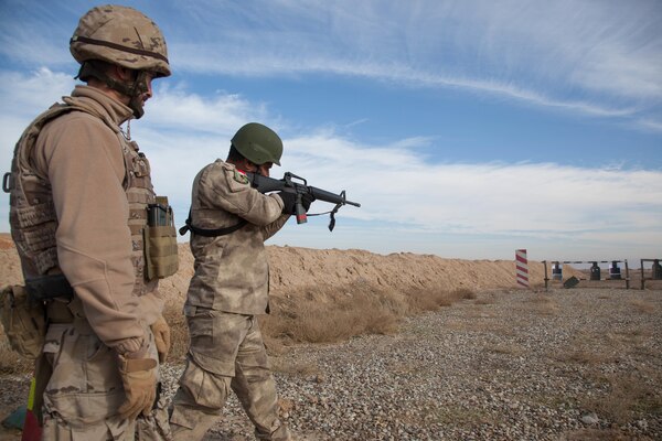 An Iraqi security forces soldier fires his M16A2 as a Portuguese trainer observes during training at Besmaya Range Complex, Iraq, Jan. 06, 2017. This training is part of the overall Combined Joint Task Force - Operation Inherent Resolve building partner capacity mission to aid partnered forces fighting ISIL. CJTF-OIR is the global Coalition to defeat ISIL in Iraq and Syria. (U.S. Army photo by Sgt. Joshua Wooten)