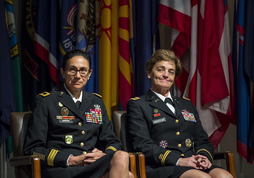 Brig. Gen. Marion Garcia, commanding general, 200th Military Police Command and Chief Warrant Officer 5 Mary Alice Hostetler listen to one the speakers at the Women's Millitary Memorial on Jan. 7 in Arlington, Virginia. Hostetler enlisted into the Army in July 1976 and was promoted to CW5 in April 2013 as the Command Chief Warrant Officer of the 200th Military Police Command. Hostetler served more than 40 years in the United States Army. Hostetler accomplished many milestones, from being the first female in a military police company, the first female to provide protective services in a combat zone, to leading a team in charge of protecting the Secretary of Defense. Hostetler says of all the things she's done in her career, the best thing she's ever done was wear the Army uniform. (Army Reserve Photo By: Sgt. 1st Class Sun Vega)