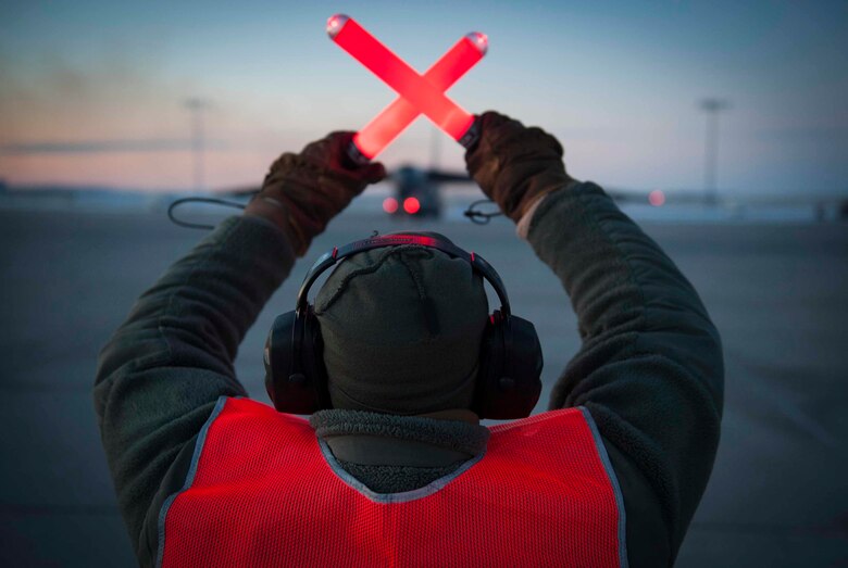 Senior Airman Taylor Lancaster, a 5th Aircraft Maintenance Squadron aircraft crew chief, guides a B-52H Stratofortress on Minot Air Force Base, N.D., Jan. 9, 2015. Lancaster’s main duty is to ensure his jet is fixed and prepared to take off before its flight time. (U.S. Air Force photo/Airman 1st Class Sahara L. Fales)