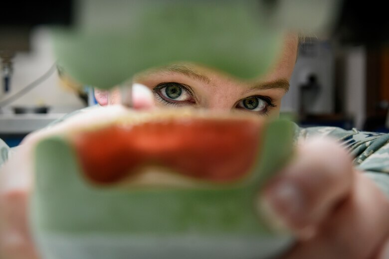 Senior Airman Angelique Culver, a 59th Dental Support Squadron dental lab technician, examines dentures at Joint Base San Antonio-Lackland, Texas, Jan. 26, 2016. The 59th DSS supports more than 90,000 patients, seven residencies and two dental fellowships by providing a high-performance health system dedicated to excellence in global dental care and education. (U.S. Air Force photo/Senior Airman Keith James)