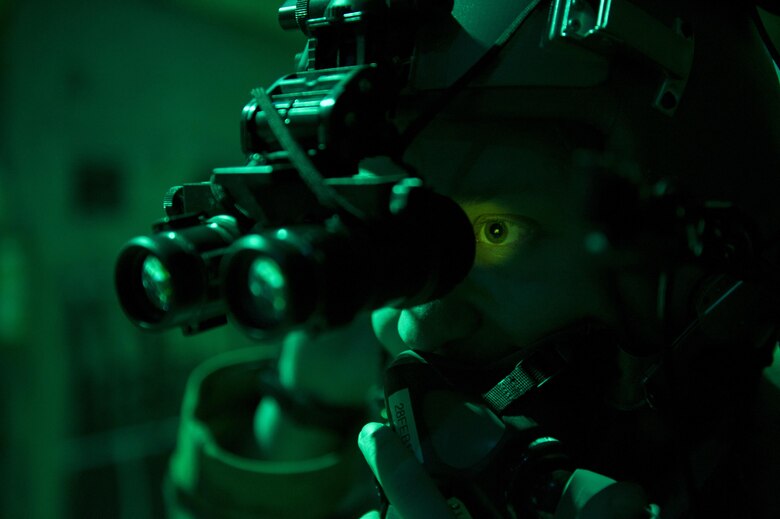 Senior Airman Noah Lindquist, a 774th Expeditionary Airlift Squadron loadmaster, tests his night vision goggles in the back of a C-130J Super Hercules before a sortie at Bagram Airfield, Afghanistan, Feb. 22, 2016. Loadmasters are responsible for calculating aircraft weight, balancing records and cargo manifests, conducting cargo and personnel airdrops, scanning for threats, and troubleshooting in-flight problems. (U.S. Air Force photo/Tech. Sgt. Robert Cloys)