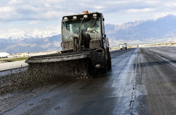 Staff Sgt. Travis Bowersock, a 577th Expeditionary Prime BEEF Squadron paint team lead, clears away dissolved rubber with a Toolcat utility work machine during rubber removal operations at Bagram Airfield, Afghanistan, April 4, 2016. The team travels throughout the U.S. Air Forces Central Command area of responsibility cleaning runways, some up to 420,000 square feet. (U.S. Air Force photo/Tech. Sgt. Nicholas Rau)