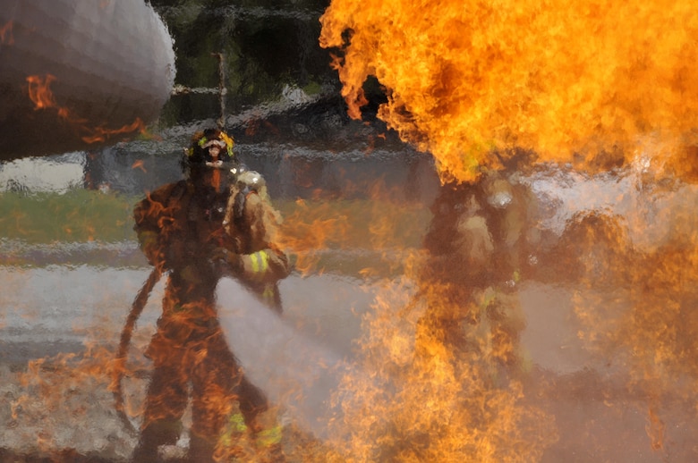 Airmen from the Connecticut, Maine, New Jersey, Rhode Island, and Vermont Air National Guard fire departments perform a live aircraft fire training exercise at 165th Airlift Wing's Regional Fire Training Facility in Savannah, Ga., April 4, 2016. The Airmen conducted joint training exercises to maintain operational readiness. (U.S. Air National Guard photo/Tech. Sgt. Andrew J. Merlock)