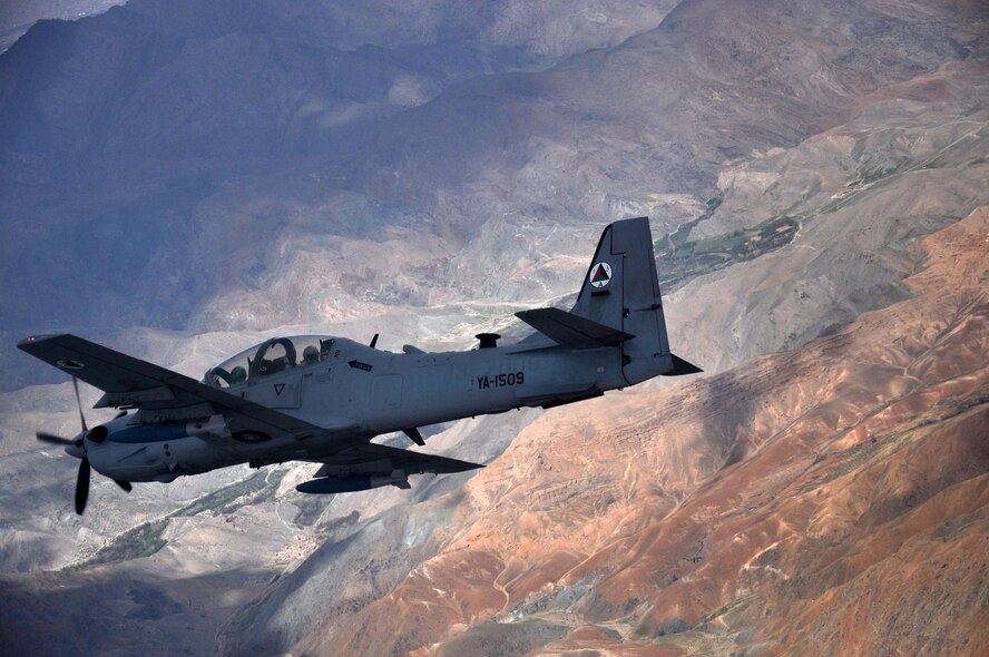 An A-29 Super Tucano flies over Afghanistan during a training mission April 6, 2016. The A-29 is a light attack aircraft that can be armed with two 500-pound bombs, twin .50-caliber machine guns and rockets. Aircrews are trained on aerial interdiction and armed overwatch missions that enable a pre-planned strike capability. The Afghan air force currently has eight A-29s but will have 20 by the end of 2018. Train, Advise, Assist Command-Air (TAAC-Air) works daily with the Afghan air force to help build a professional, sustainable and capable air force. (U.S. Air Force photo by Capt. Eydie Sakura/released)