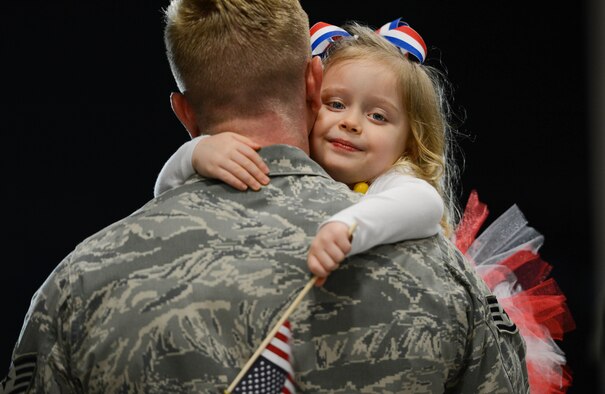 An Airman assigned to the 20th Fighter Wing is embraced by his daughter after returning to Shaw Air Force Base, S.C., April 13, 2016. Approximately 300 Airmen deployed for six months to the U.S. Central Command area of responsibility. (U.S. Air Force photo/Senior Airman Jensen Stidham)