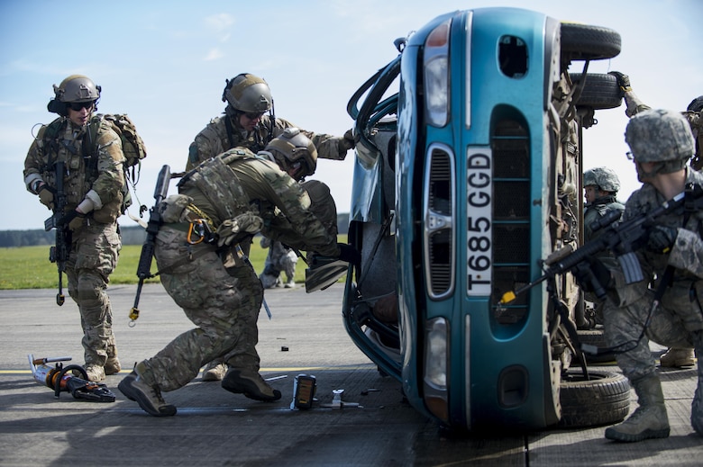 Pararescuemen assigned to the 57th Rescue Squadron use the Jaws of Life to tear apart a vehicle's roof to remove a mock victim during a combat search and rescue demonstration at Royal Air Force Lakenheath, England, April 21, 2016. Pararescuemen and members of the 48th Security Forces Squadron demonstrated the rescue during a Chief of Staff of the Air Force Civic Leader Program visit. (U.S. Air Force photo/Staff Sgt. Emerson Nuñez)