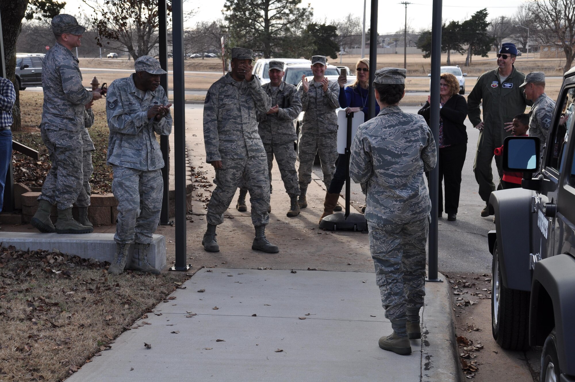 Master Sgt. Steven Pruitt is overcome with surprise as he learns that he’s the winner of a 2017 Jeep Wrangler, the grand prize in the Air Force Services Activity's Air Force Club Membership Giveaway, at Tinker Air Force Base, Oklahoma, Dec. 21, 2016. Col. Donna L. Turner, AFSVA commander, (with back to camera) made the announcement at Pruitt’s squadron commander’s call. Pruitt, the NCO in charge of the Cyber Security Office, 552nd Air Control Network Squadron, entered the giveaway 20 times; his name was randomly generated from more than 11,000 entries. The squadron was called outside under the guise of a safety briefing for winter driving. (U.S. Air Force photo by Annette Crawford)