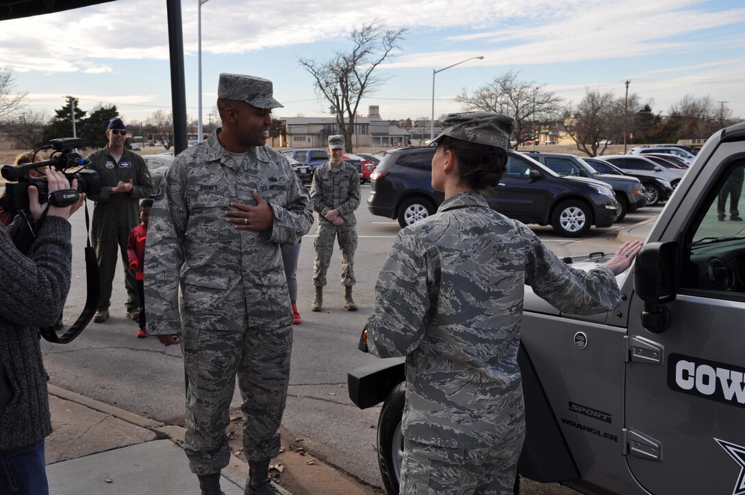 Col. Donna Turner, Air Force Services Activity commander, points out the Dallas Cowboys logos on the 2017 Jeep Wrangler to the vehicle’s new owner, Master Sgt. Steven Pruitt, 552nd Air Control Network Squadron, at Tinker Air Force Base, Oklahoma, Dec. 21, 2016. The Jeep was the grand prize in the AFSVA Air Force Club Membership Giveaway. Pruitt, the NCO in charge of the Cyber Security Office, entered the giveaway 20 times; his name was randomly generated from more than 11,000 entries. (U.S. Air Force photo by Annette Crawford)