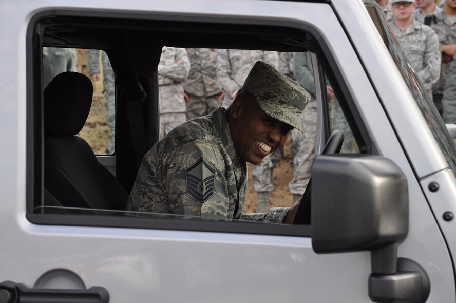 Master Sgt. Steven Pruitt is all smiles as he sits in his new 2017 Jeep Wrangler, the grand prize in the Air Force Services Activity's Air Force Club Membership Giveaway, at Tinker Air Force Base, Oklahoma, Dec. 21, 2016. Col. Donna L. Turner, AFSVA commander, presented the keys at Pruitt’s squadron commander’s call. Pruitt, the NCO in charge of the Cyber Security Office, 552nd Air Control Network Squadron, entered the giveaway 20 times; his name was randomly generated from more than 11,000 entries. (U.S. Air Force photo by Annette Crawford)