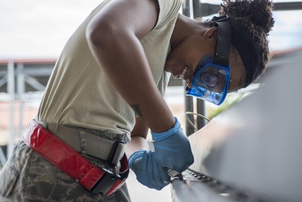 Senior Airman Dejahnay Truesdale, a 31st Maintenance Squadron aerospace ground equipment journeyman, fixes the bumper pad on a maintenance stand June 20, 2016, at Aviano Air Base, Italy. The bumper pad wraps around the edge of the stand to ensure it does not damage an aircraft when maintenance is performed. (U.S. Air Force photo/Airman 1st Class Cory W. Bush)