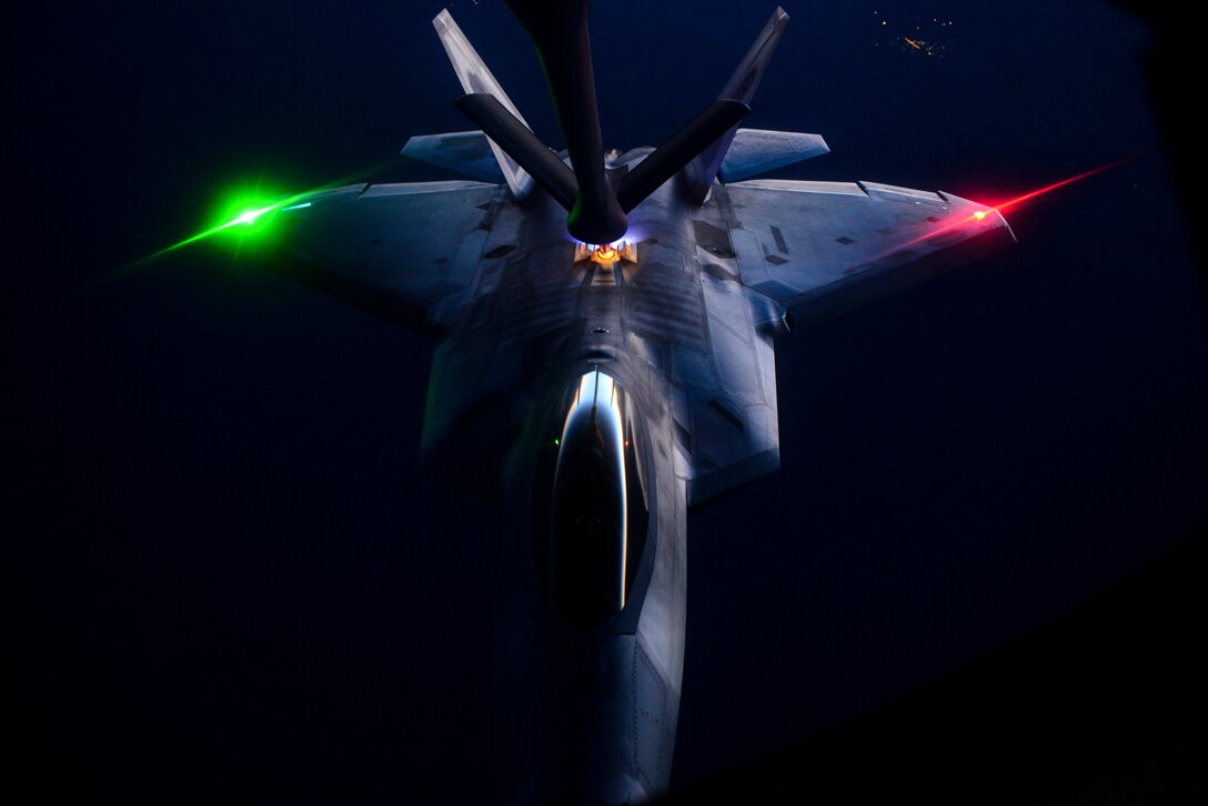 An F-22 Raptor is refueled by a KC-135 Stratotanker over the Nevada Test and Training Range during the U.S. Air Force Weapons School’s Deliberate Strike Night, June 16, 2016. The exercise is part of the final seven-day advanced integration portion of the school’s curriculum, testing stealth and conventional airframes’ abilities to conduct attacks during the hours after sunset. (U.S. Air Force photo/Airman 1st Class Kevin Tanenbaum)