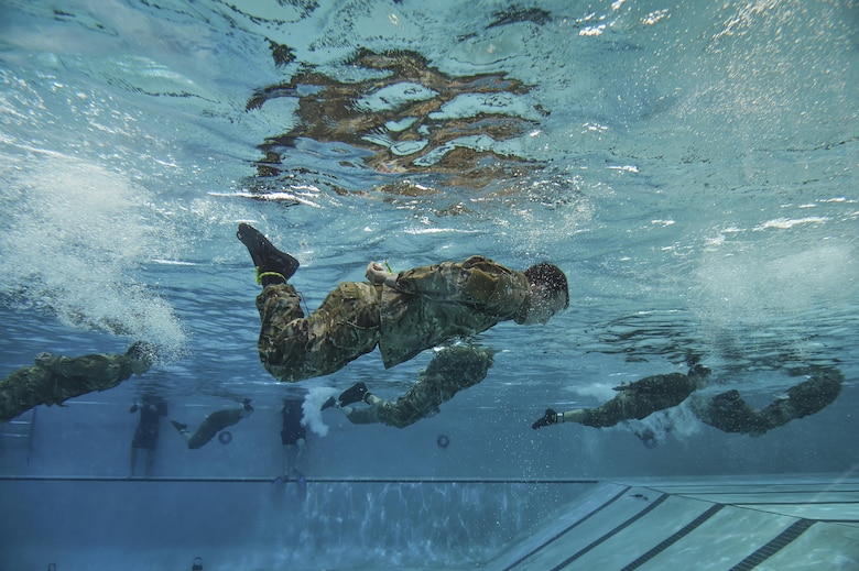 Special Tactics Training Squadron students swim the length of the pool with their hands and feet bound during a pre-scuba class at Hurlburt Field, Fla., June 29, 2016. The training familiarizes trainees with the basics of water operations. Trainees perform tasks such as tying knots underwater, staying afloat without their arms and hands, and using snorkeling gear. (U.S. Air Force photo/Senior Airman Ryan Conroy)