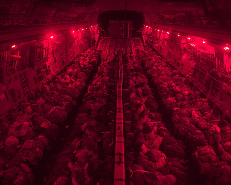 Soldiers from the 82nd Airborne Division prepare to jump in the Sicily Drop Zone out of a C17 Globemaster III during battalion mass tactical week at Pope Army Airfield, N.C., July 12, 2016. Army and Air Force units worked together during joint readiness exercises to improve interoperability for worldwide crisis, contingency and humanitarian operations. (U.S. Air Force photo/Staff Sgt. Sandra Welch)