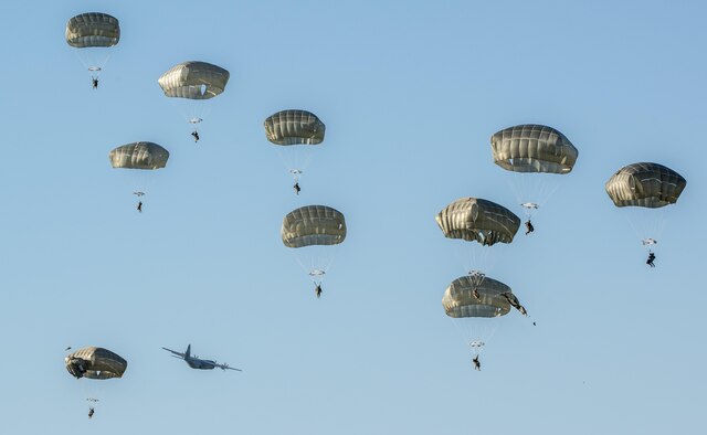 U.S. Army 173rd Airborne Brigade and German Army 1st Airborne Brigade paratroopers parachute during a joint airborne operation near Aviano Air Base, Italy, Aug. 25, 2016. The paratroopers trained on airfield clearance after jumping out of a C-130 Hercules from the 86th Airlift Wing, Ramstein Air Base, Germany after departing from Aviano AB. (U.S. Air Force photo/Airman 1st Class Cory W. Bush)