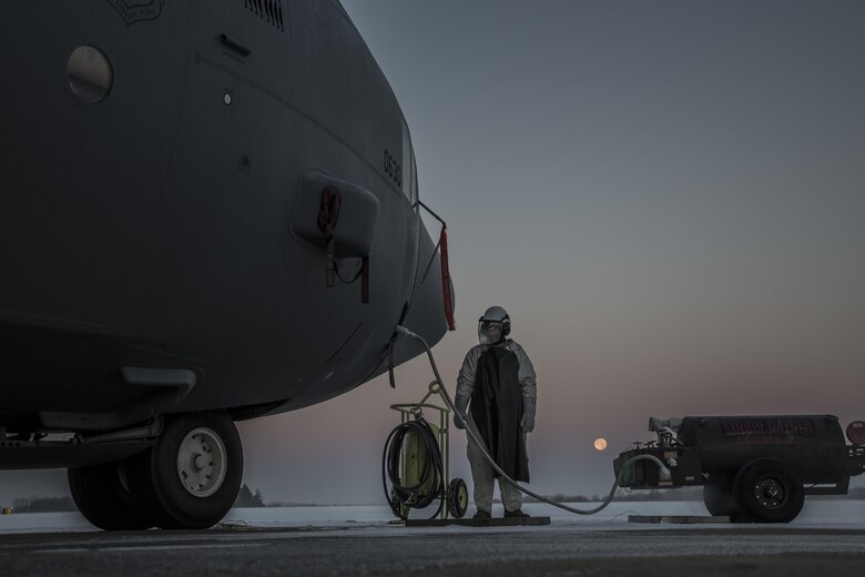 Tech. Sgt. Jordan Brown refills a C-130H Hercules with liquid oxygen as the super moon sets over a frozen flightline in the early morning at the 179th Airlift Wing, Mansfield, Ohio, Dec. 14, 2016. The 179th Airlift Wing is always on a mission to be the first choice to respond to state and federal missions with a trusted team of Airmen. (U.S. Air National Guard photo/Tech. Sgt. Joe Harwood)