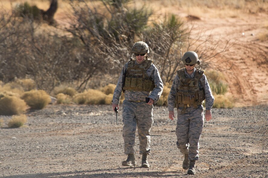 Master Sgt. Rob Shuman, the 49th Civil Engineer Squadron explosive ordnance disposal quality assurance manager, and Staff Sgt. Jacque Risley, a 49th Civil Engineer Squadron EOD technician, walk back to the safe area after investigating a potential unexploded ordnance, Jan. 6, 2017 at Holloman Air Force Base, N.M. Holloman’s EOD unit was alerted by the U.S. Border Patrol about the potential UXO. (U.S. Air Force photo by Tech. Sgt. Amanda Junk)