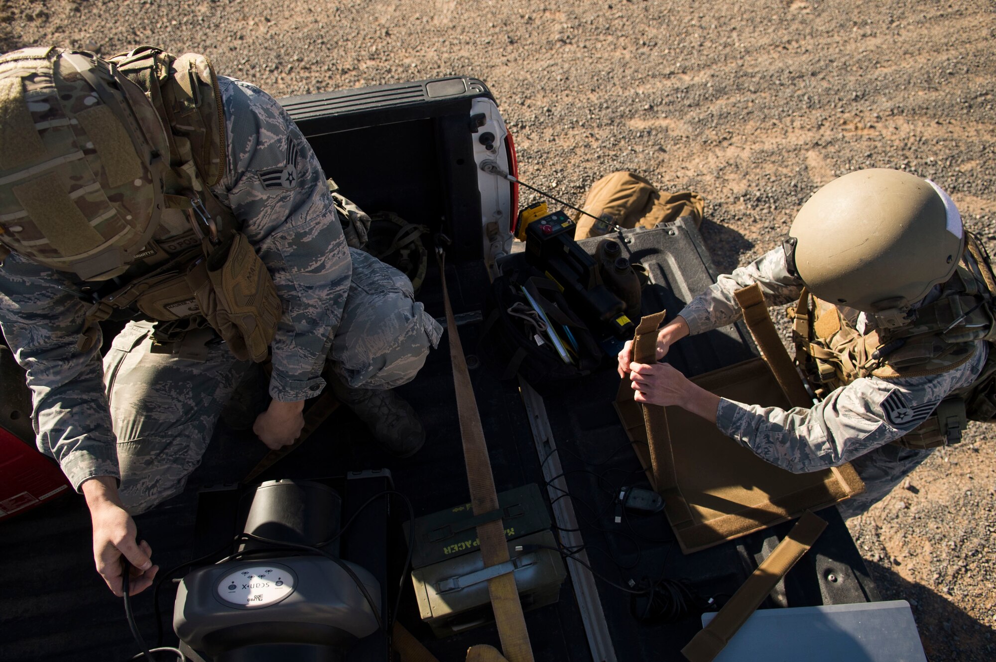 Senior Airman Matt Maurer (left), and Staff Sgt. Jacque Risley, both 49th Civil Engineer Squadron explosive ordnance disposal technicians, assemble an explosive device X-ray machine during an EOD operation Jan. 6, 2017 at Holloman Air Force Base, N.M. Holloman’s EOD unit was alerted by the U.S. Border Patrol about the potential unexploded ordnance. (U.S. Air Force photo by Tech. Sgt. Amanda Junk)