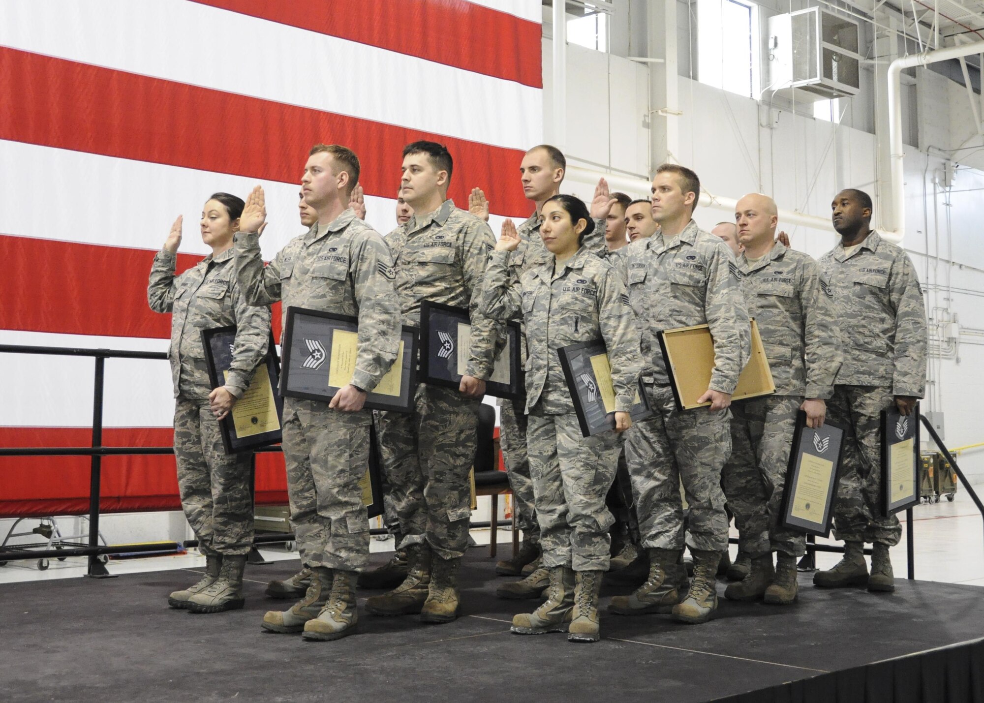 Inductees with the 442d Maintenance Group recite the non-commissioned officer creed during the NCO and Senior NCO induction ceremony at Whiteman Air Force Base, Missouri, Jan. 7, 2017. The ceremony is a tradition to congratulate Airmen in their new position while reminding SNCOs how far they've come and inspiring NCOs to continue developing their leadership abilities. (U.S. Air Force photo/Senior Airman Missy Sterling)
