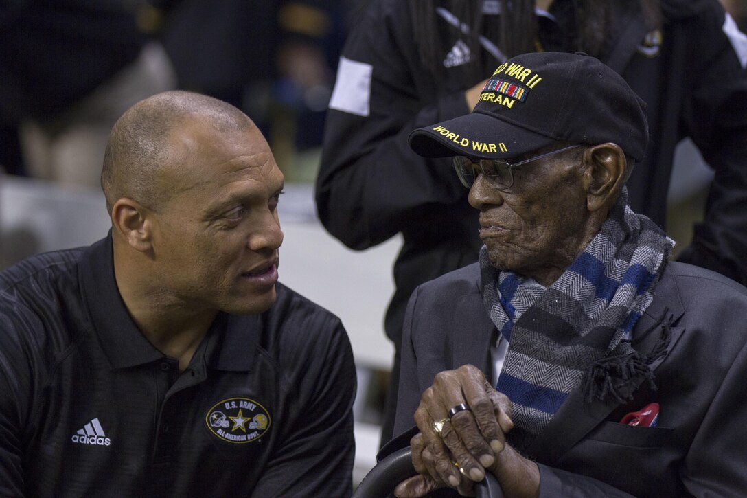 Pro Football Hall of Famer Aeneas Williams shares a moment with 110-year-old former U.S. Army Sgt. Richard Overton, the oldest living World War II veteran, before Overton took to the field to deliver the game ball at the 2017 U.S. Army All-American Bowl. The All-American Bowl is the nation’s premier high school football game, which was played Jan. 7, at the San Antonio Alamodome. (U.S. Army Reserve photo by Spc. James Lefty Larimer, 367th Mobile Public Affairs Detachment)